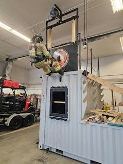 The TRUBLUE iQ fall protection device is designed to provide enhanced safety while firefighters train on the more complex elements of the Series 12 prop, such as the second-story bailout, adjustable pitched roof, and man hatch. The TRUBLUE iQ fall protection device is designed to provide enhanced safety while firefighters train on the more complex elements of the Series 12 prop, such as the second-story bailout, adjustable pitched roof, and man hatch.