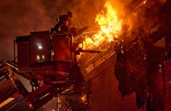 FDNY Tower Ladder 119 operates on the top floor as heavy fire vents from a three-story mixed-occupancy during a four-alarm fire in the Williamsburg neighborhood. FDNY Tower Ladder 119 operates on the top floor as heavy fire vents from a three-story mixed-occupancy during a four-alarm fire in the Williamsburg neighborhood.