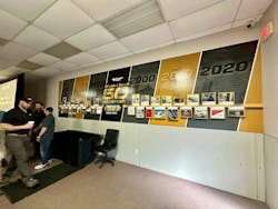 A wall inside the Wheeled Coach Delivery Center showcases the history of the company's first 50 years. A wall inside the Wheeled Coach Delivery Center showcases the history of the company's first 50 years.