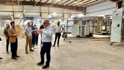Greg DeForge, national sales manager for Wheeled Coach, talks about the Wheeled Coach production process with a group inside the paint building. Greg DeForge, national sales manager for Wheeled Coach, talks about the Wheeled Coach production process with a group inside the paint building.