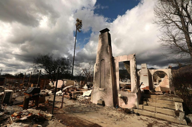 A chimney, a door frame and steps are all that remains of a home destroyed in the Eaton fire n Altadena.