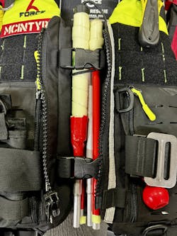 A collapsible blind walking cane (shown here in the folded position and stored behind the zipper and buckles on a rescue PFD) can be used for an individual to stand at a particular spot, check a floor in a flooded building, check the depth for boat motors and wading. A collapsible blind walking cane (shown here in the folded position and stored behind the zipper and buckles on a rescue PFD) can be used for an individual to stand at a particular spot, check a floor in a flooded building, check the depth for boat motors and wading.