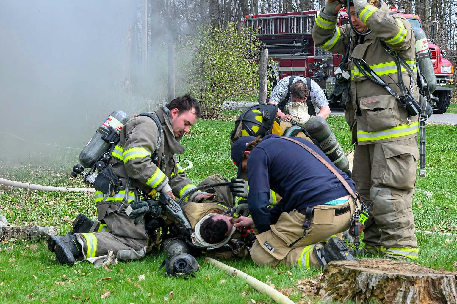 EMTs treat Convoy Firefighter Jake Hicks who was caught in a flashover.