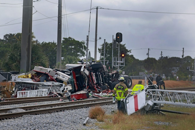 The $1 million aerial truck was hit by a train after the driver drove around the crossing gates.