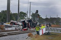 The $1 million aerial truck was hit by a train after the driver drove around the crossing gates. The $1 million aerial truck was hit by a train after the driver drove around the crossing gates.