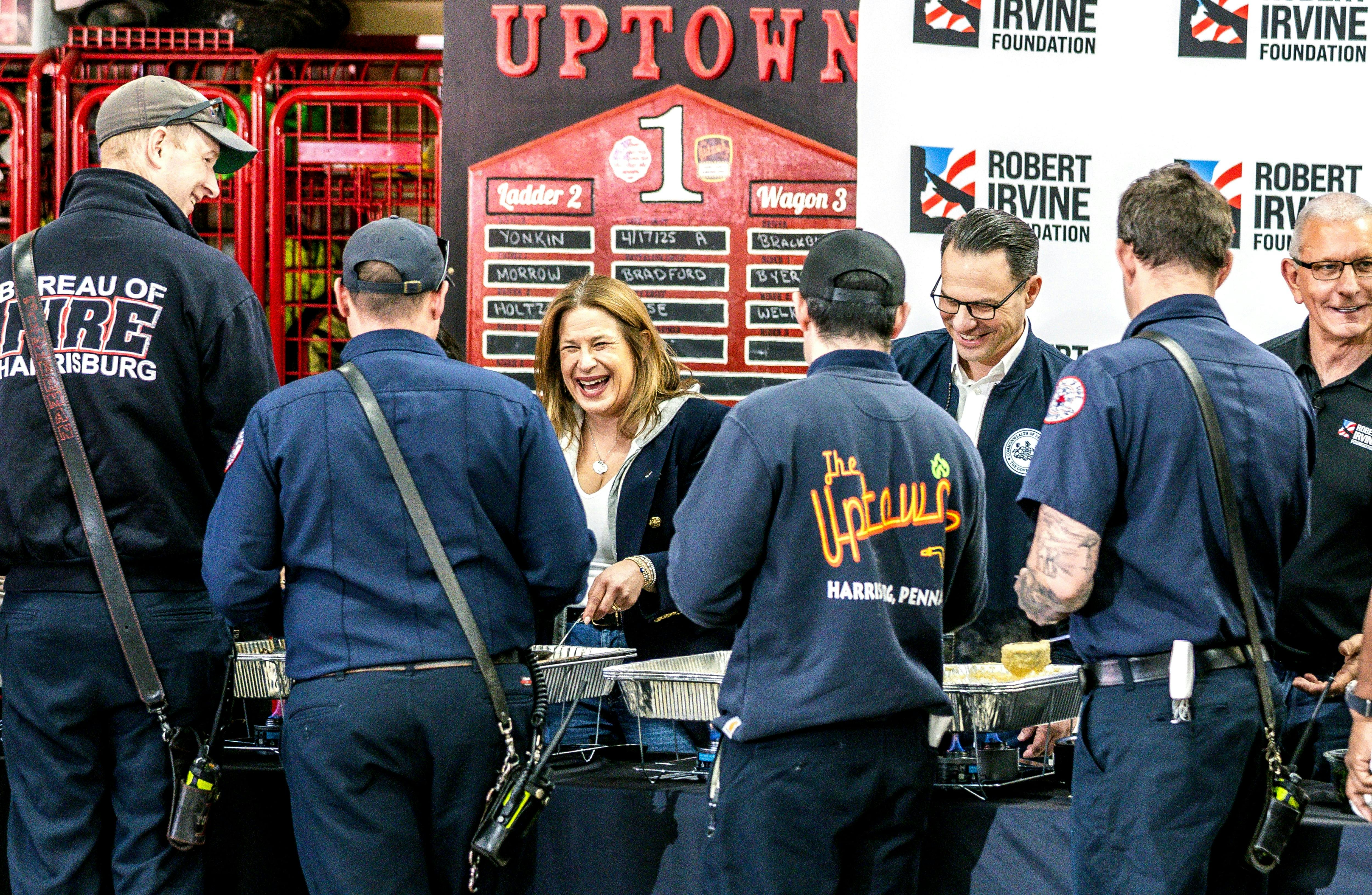 First lady Lori Shapiro laughs as she serves lunch to Harrisburg firefighters who responded to the fire.