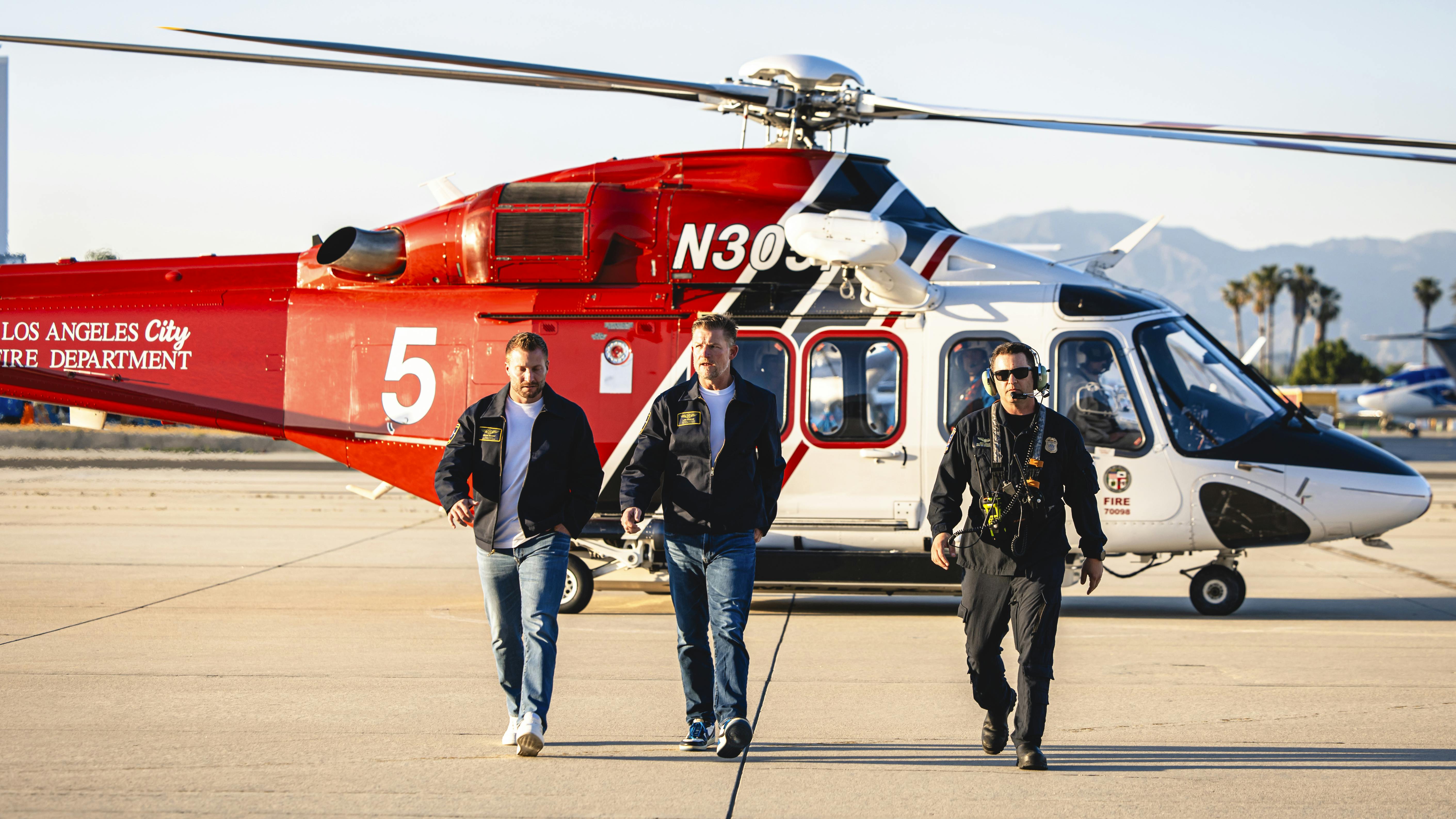 LA Rams Head Coach Sean McVay and General Manager Les Snead walk with Los Angeles Fire Department Battalion Chief Brett Willis during a promotional video shoot for the NFL draft.