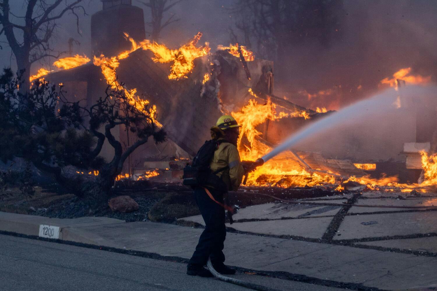 A firefighter works to contain the Palisades fire in January.
