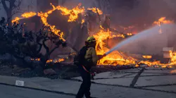 A firefighter works to contain the Palisades fire in January.