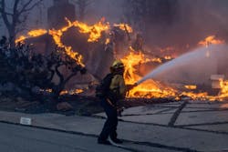 A firefighter works to contain the Palisades fire in January. A firefighter works to contain the Palisades fire in January.