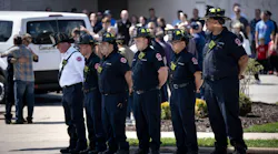 Chicago firefighters wait as an escort arrives with Capt. David Meyer at Malec & Sons Funeral Home.