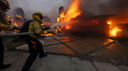 Firefighters battle the Palisades fire on El Medio Ave. on Jan. 7.