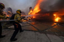 Firefighters battle the Palisades fire on El Medio Ave. on Jan. 7. Firefighters battle the Palisades fire on El Medio Ave. on Jan. 7.