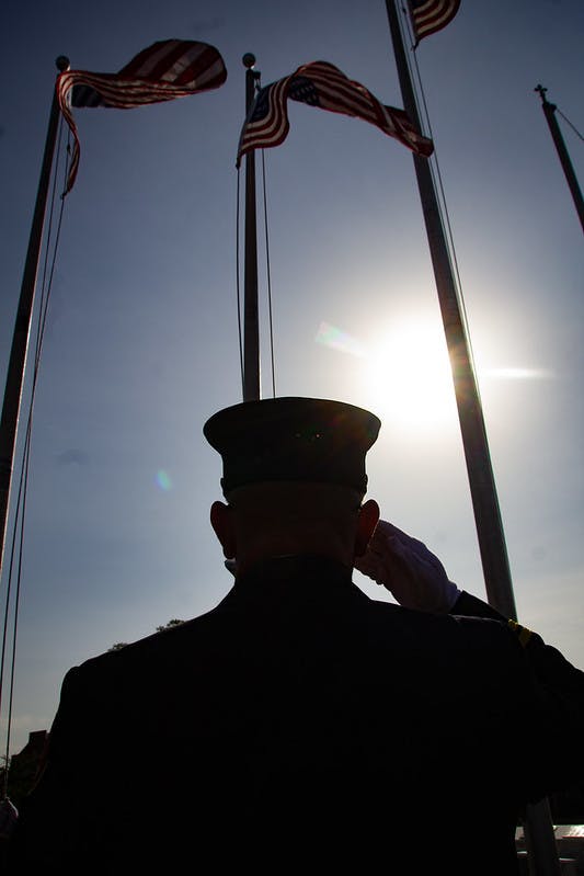 A firefighter salutes at the National Fallen Firefighters. Memorial.