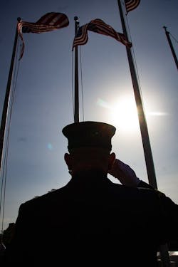 A firefighter salutes at the National Fallen Firefighters. Memorial. A firefighter salutes at the National Fallen Firefighters. Memorial.