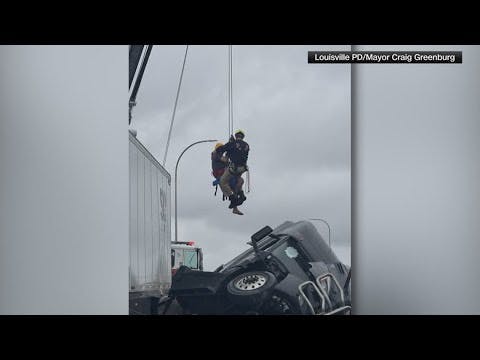 Firefighters rescue man dangling off Louisville bridge in semi