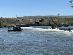 A Benton County firefighter aboard a sinking boat, right, waits to be rescued. A Benton County firefighter aboard a sinking boat, right, waits to be rescued.