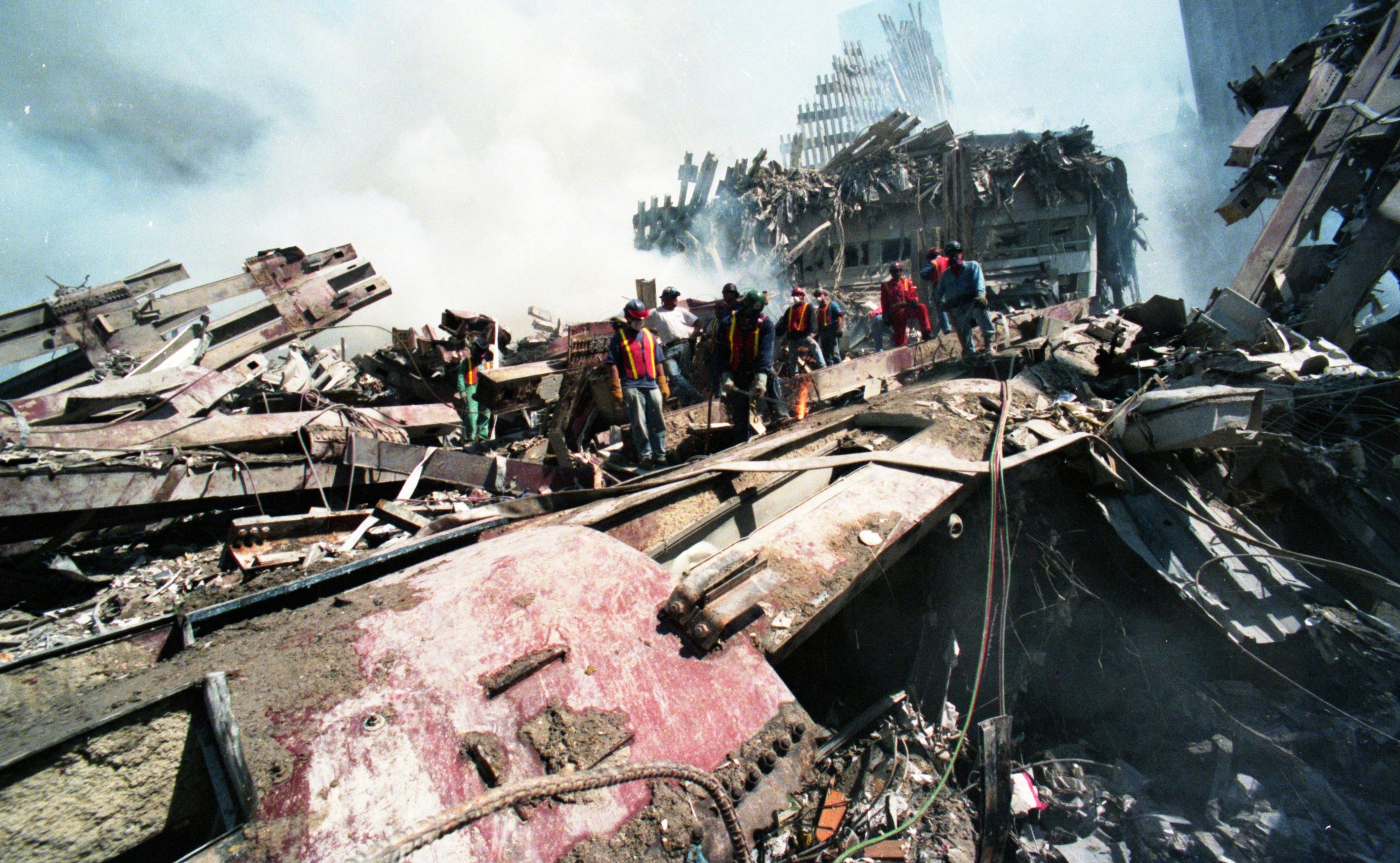 FDNY firefighters search the ruins of the World Trade Center.
