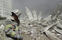 A firefighter stands at the ruins of the World Trade Center. A firefighter stands at the ruins of the World Trade Center.