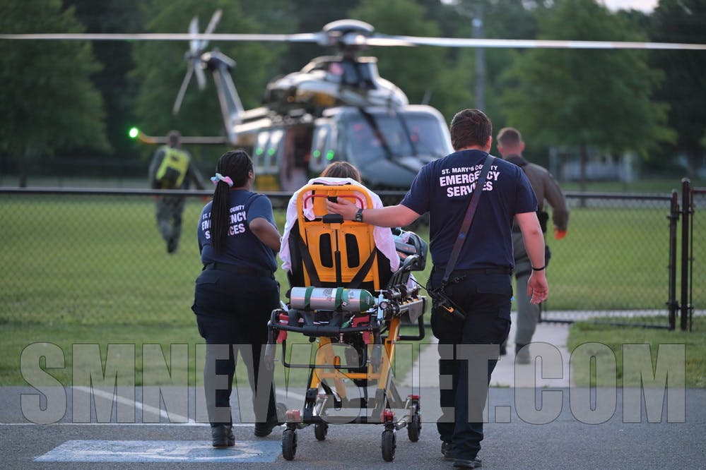 St. Mary's County EMS crews head toward a Maryland State Police helicopter Saturday morning.