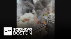 Firefighter working detail helps evacuate office building on fire in Downtown Boston