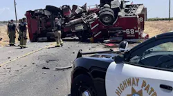 Two firefighters were hurt when their fire truck overturned after a collision.