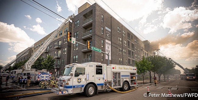 Fort Worth Engine 5 supplies water as four aerial ladders operate during a six-alarm fire Monday.
