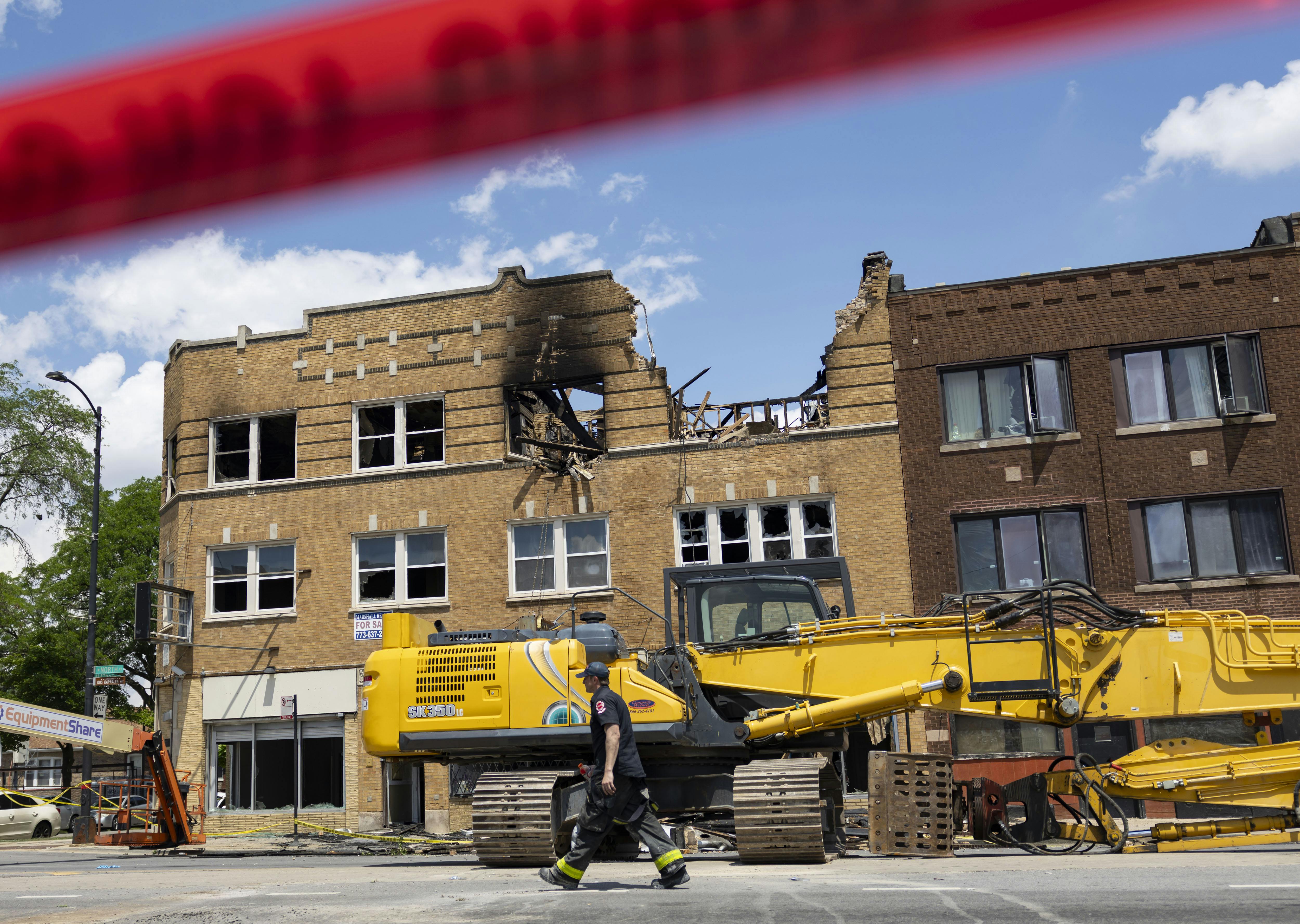Firefighters work at the scene of a fire that claimed the lives of four people in Chicago's Austin neighborhood on June 26.