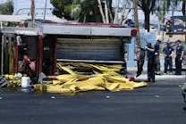 Firefighters were responding to a house fire Thursday when the rig overturned and emptied the hose bed. Firefighters were responding to a house fire Thursday when the rig overturned and emptied the hose bed.