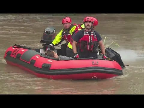 Kansas City crews able to rescue woman clinging to a tree in rushing flood waters