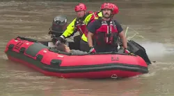 Kansas City crews able to rescue woman clinging to a tree in rushing flood waters