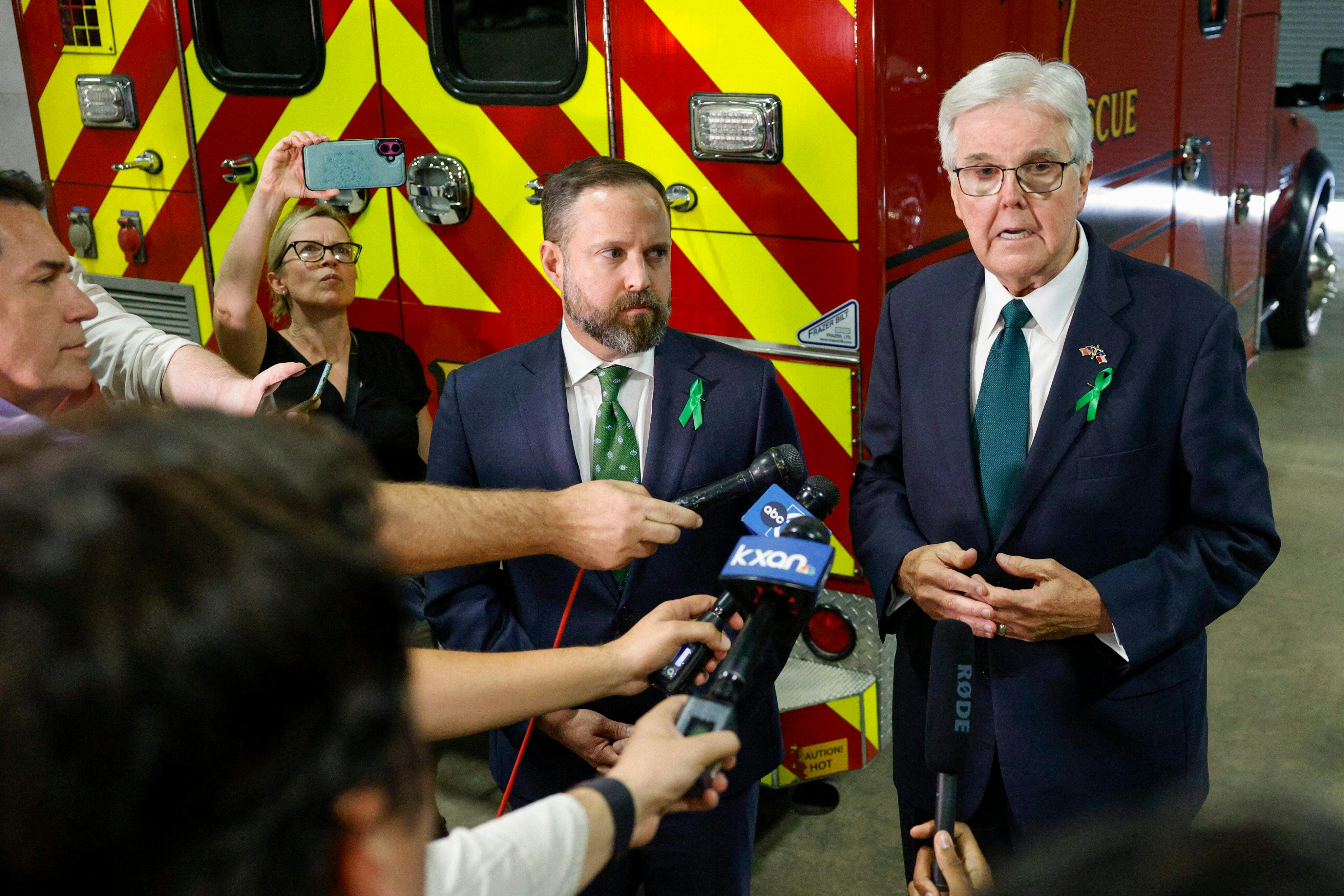 Texas Lt. Gov. Dan Patrick speaks to reporters alongside House Speaker Dustin Burrows outside a joint hearing on disaster preparedness and flooding,