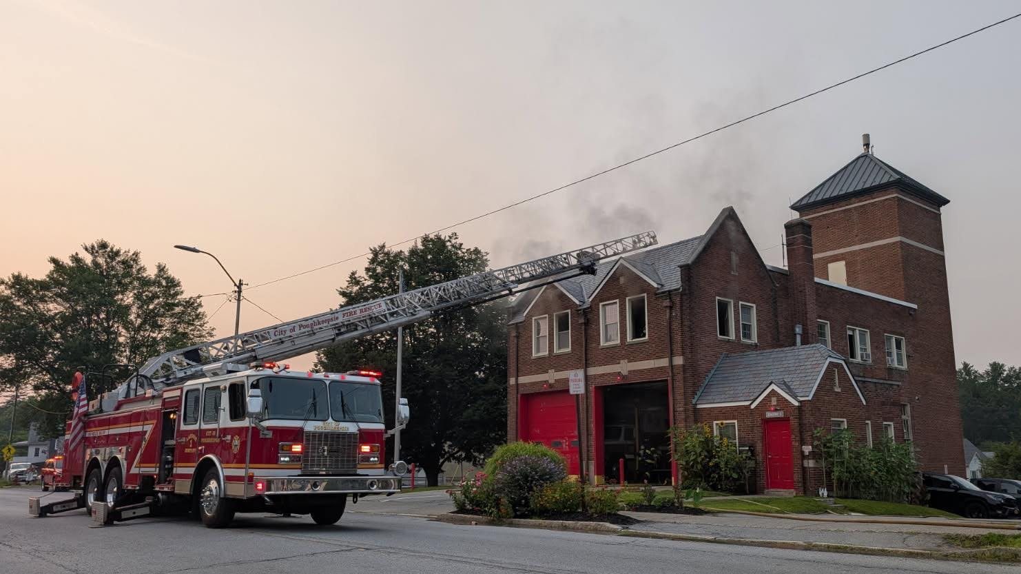 A ladder truck is positioned to the roof of Poughkeepsie Fire Station 3 Tuesday after fire caused extensive damage to the 99-year-old firehouse.