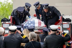 Firefighters load the casket of Kansas City Paramedic Graham Hoffman onto a fire truck. Firefighters load the casket of Kansas City Paramedic Graham Hoffman onto a fire truck.