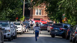 A woman runs toward the Annunciation Church in south Minneapolis after a mass shooting Wednesday.