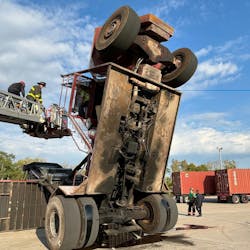 Georgetown firefighters reaching the patient on the crane. Georgetown firefighters reaching the patient on the crane.