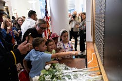 Children look at the World Trade Center Memorial Wall during a ceremony at the FDNY Headquarters Tuesday. Children look at the World Trade Center Memorial Wall during a ceremony at the FDNY Headquarters Tuesday.