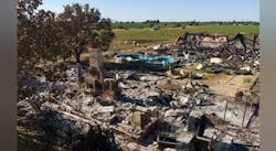 A chimney stands amid the rubble of a structure at a fireworks explosion site. A chimney stands amid the rubble of a structure at a fireworks explosion site.