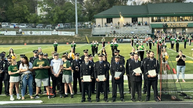 The five firefighers involved in the rescue were recognized during a ceremony at Penn-Trafford's Warrior Stadium before the high school football game.