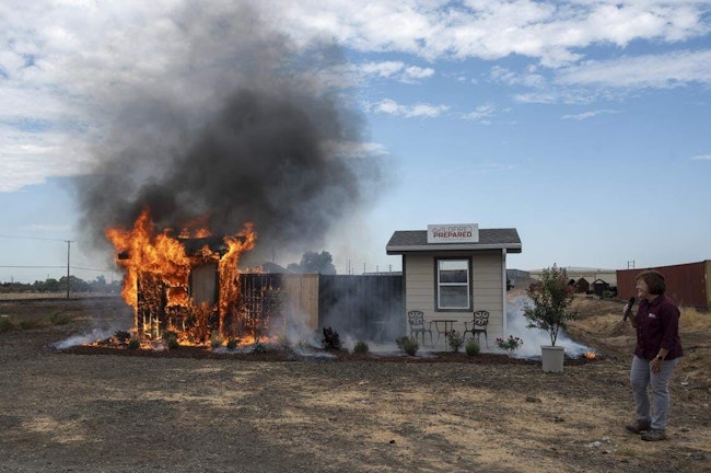 Anne Cope, chief engineer for Insurance Institute for Business and Home Safety, speaks during a burn demonstration at the Sacramento City Fire Training Facility at McClellan Airfield on Wednesday.