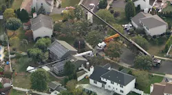 Crane collapses onto NJ home while moving hot tub