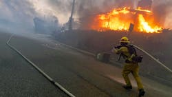A firefighter works at the Palisades fire in January. A firefighter works at the Palisades fire in January.