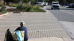 A homeless woman sits in a park in Malibu, CA.