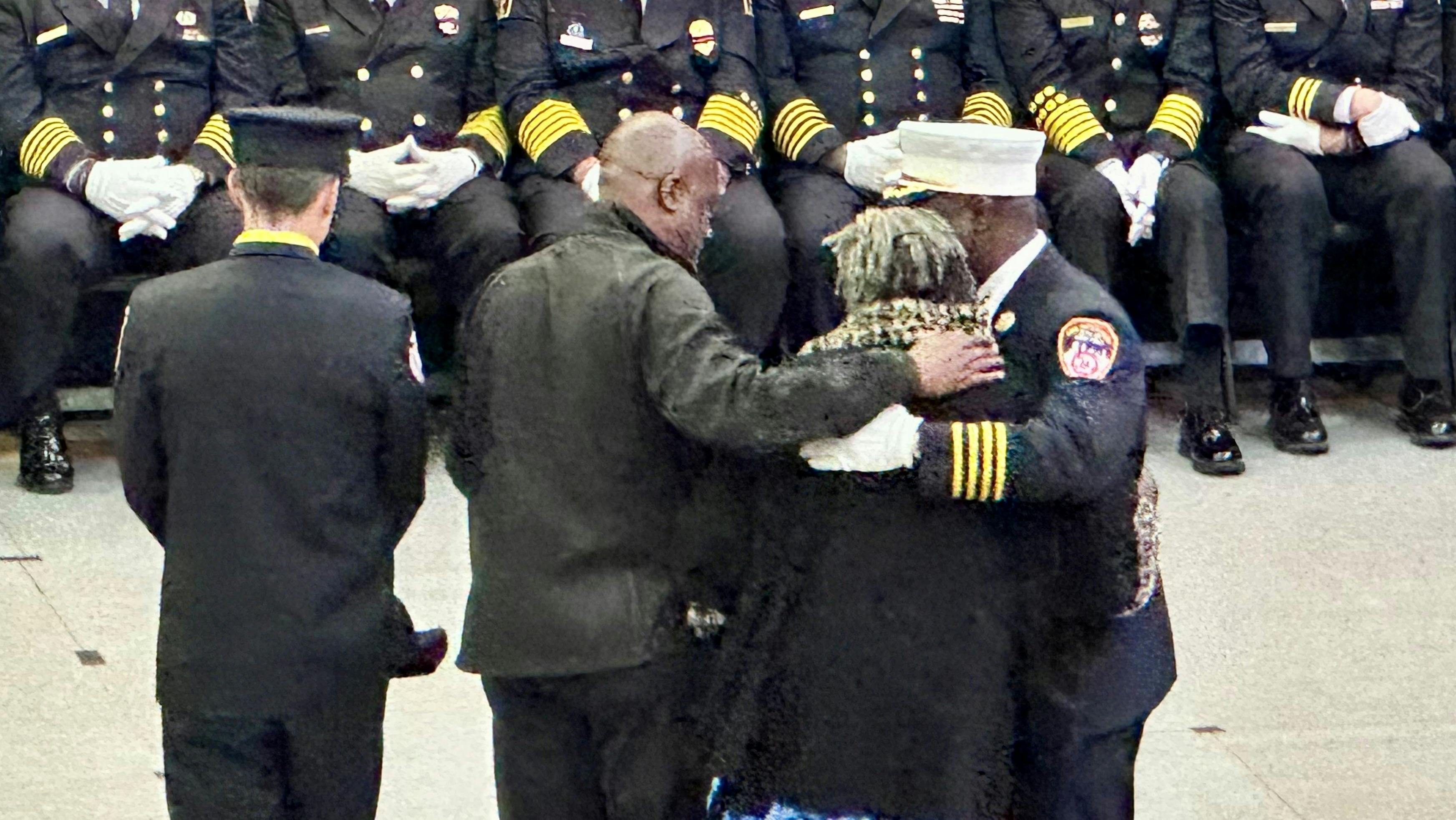 FDNY Chief of Special Operations Malcom Moore (right) embraces the family of Charles Williams. Williams served as a mentor to Moore when he first joined the department and worked on Engine 214.