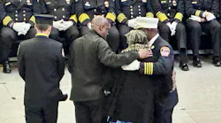 FDNY Chief of Special Operations Malcom Moore (right) embraces the family of Charles Williams. Williams served as a mentor to Moore when he first joined the department and worked on Engine 214.