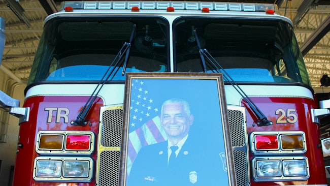 A portrait of the late Alexander G. Trenier sits on the front of a truck in the Mobile fire station that bears his name.