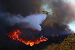 A firefighting plane drops water on the Palisades fire on Jan. 7, 2025. A firefighting plane drops water on the Palisades fire on Jan. 7, 2025.