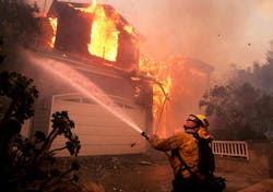 A firefighter battles a house fire in January during the Palisades fire. A firefighter battles a house fire in January during the Palisades fire.