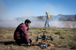 University of Minnesota researcher Nikil Krishnakumar prepares a drone to fly through smoke while Department of Natural Resources staff light a backfire in East Bethel, MN, last month. University of Minnesota researcher Nikil Krishnakumar prepares a drone to fly through smoke while Department of Natural Resources staff light a backfire in East Bethel, MN, last month.