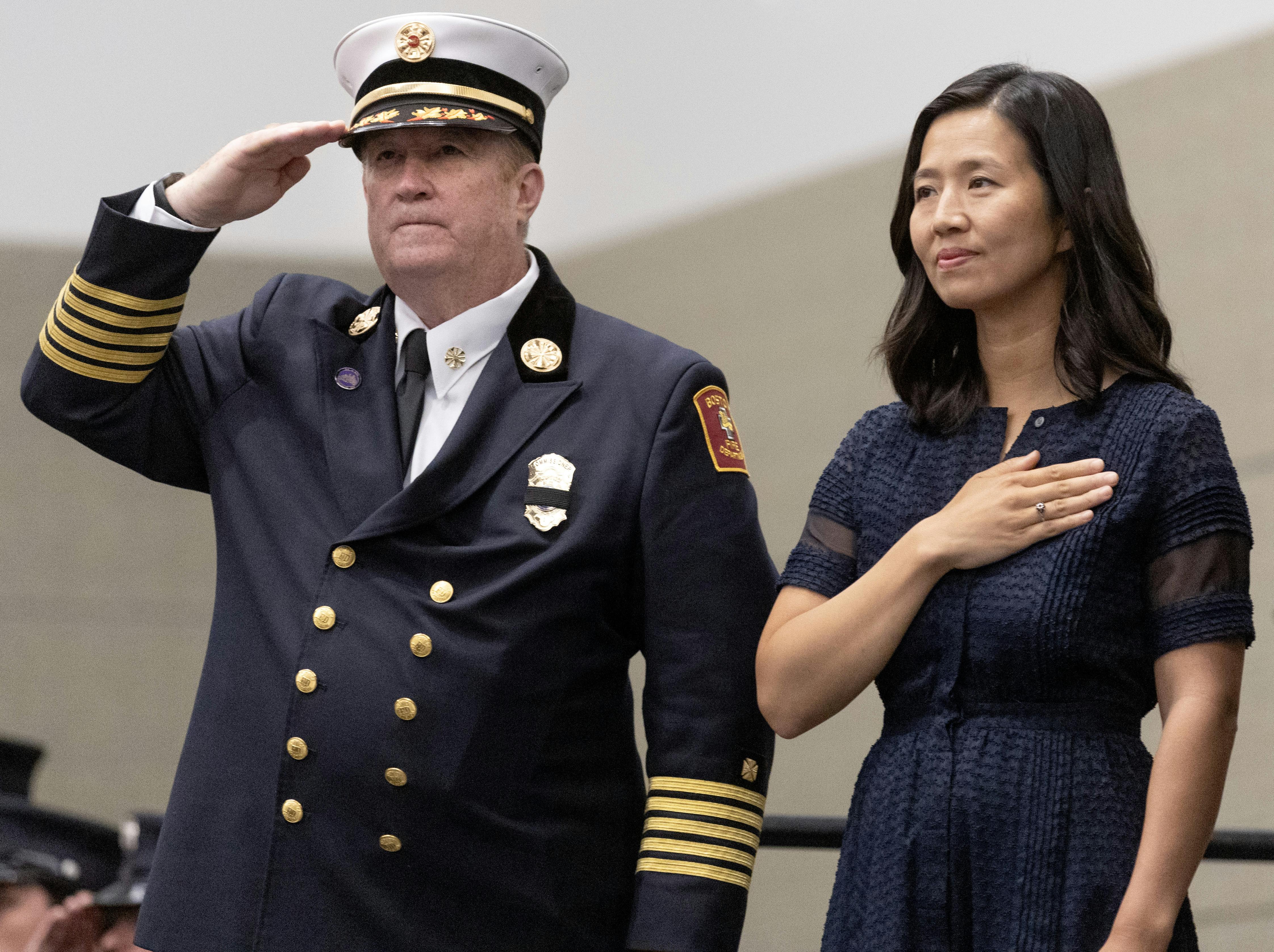 Boston Fire Commissioner Paul Burke and Mayor Michelle Wu stand at a recent fire department graduation ceremony